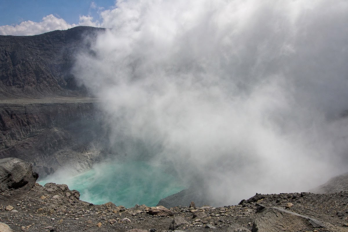 Afternoon cloud beginning to spill over the crater rim of Santa Ana Volcano while the lake still shows through