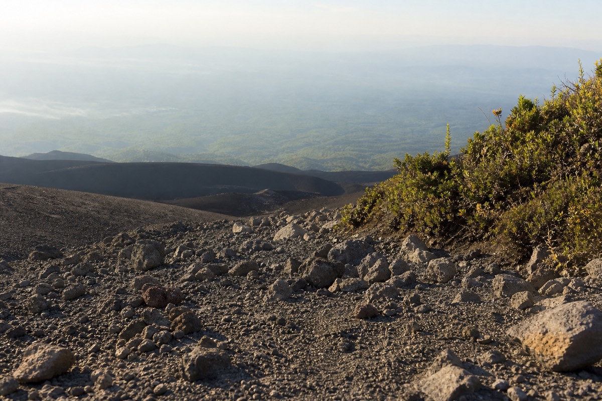 Loose sharp volcanic rubble on the final stretch of the Santa Ana Volcano trail in early morning light